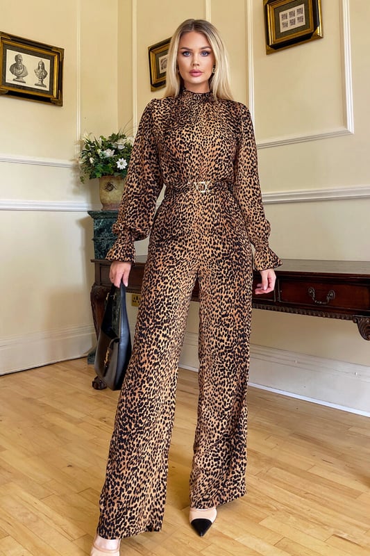 Our Camel Animal Belted Frill Cuff Sleeve Jumpsuit is perfect to throw
on and go whilst still looking put together, designed in a classic
animal print which will never go out of style . Featuring a Gold
Statement belt, a high frill trim neck, and a zip up back! Dress up
with heels for an evening look or wear with flats for a day time look.

Model wears: UK 8/ EU 36/ US 4

Model's height: 170cm/ 5'7"

Approx length from centre back to hem: 159cm

Fabric composition: 100% Polyester 

Colour:  CAMEL