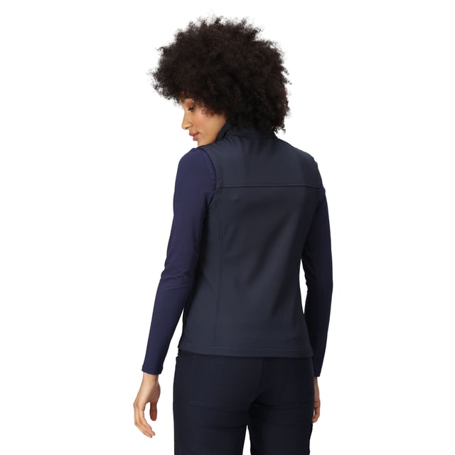 Material: 96% Polyester, 4% Elastane. Fabric: Soft Touch, Softshell, Stretch, Woven. 270gsm. Design: Plain. Fit: Shaped. Quick Dry, Water Repellent, Wind Resistant. Fabric Technology: Warm-Backed. Sleeve-Type: Sleeveless. Neckline: Zip. Pockets: 2 Lower Pockets, 1 Chest Pocket, Zip. Fastening: Zip. Hem: Adjustable, Shockcord Hem.
