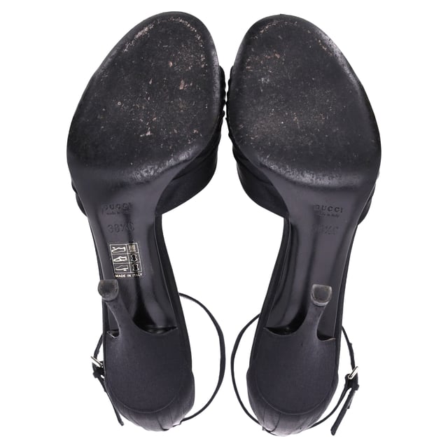 VINTAGE, RRP AS NEW
Elevate your evening ensemble with the Gucci Crystal-Embellished Open-Toe Sandal Heels in luxurious black satin. These stunning heels feature a captivating crystal embellishment that adds a touch of sparkle and glamour, perfect for any special occasion. The open-toe design elegantly showcases your pedicure, while the delicate straps provide a secure fit and enhance the overall allure of the shoe. Crafted from high-quality satin, these sandals not only look fabulous but also offer comfort for all-night wear. Pair them with your favorite cocktail dress or tailored jumpsuit to create a head-turning look that embodies the sophistication of Gucci.

 Gucci Crystal-Embellished Open-Toe Sandal Heels in Black Satin

Condition: Very good
Signs of wear: Minor markings, Lightly used but very well maintained. Minor mark at soles & creasing, light scuffing at the soles and heels.
Packaging: None
Color: Black
Material: Satin | satin
Size: IT38.5/FR39.5/UK5.5/US8.5
Measurements: Heel height: 11; Insole length: 25,5
SKU: NAPPUITSH397907W