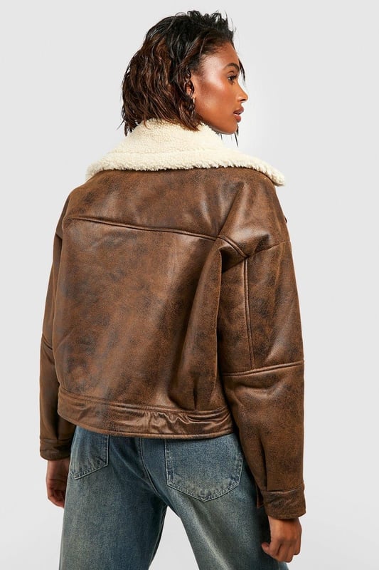Take your outfit to new style heights with an aviator jacket. Perfect for layering, create a stylish oversized silhouette as you choose from crop belted jackets to faux fur lined options. A cross between a classic flight jacket and a leather biker, it's all about the detailing with this snug winter staple. Pair your aviator coat with high waisted mom jeans and a fierce attitude as you stroll your way through your social calendar.Style: Aviator JacketFabric: Faux LeatherSleeve Length: Long Sleeve