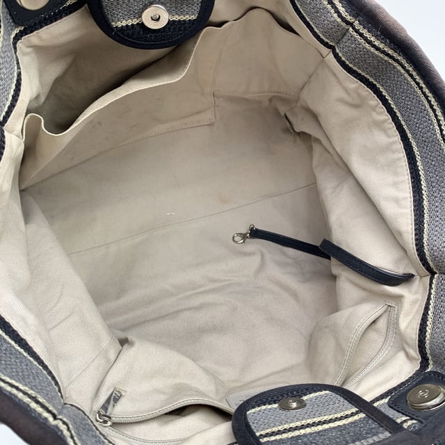 VINTAGE, RRP AS NEW
Beautiful Chanel 'Deauville' tote, crafted in black, grey and beige striped canvas with a white 'Chanel CC31, Rue cambon - Paris' logo. Period/Era: 2018/2019. Double black eather top handles and silver metal and interwoven leather shoulder straps. Magnetic button closure on top. The interior is in beige canvas lining. 2 side zip pockets inside. Leather strap with hook inside. 'CHANEL - made in Italy' tag inside. ity hologram tag inside Condition Rating: B - VERY GOOD CONDITIONCondition Details: Gently used. Some normal wear of use on bottom corners. Some darkness, small stains and normal wear of use on the internal lining. The fabric of the upper border is slightly discolored. Please, check carefully the photos or ask if you have any doubts. Measurements (cm):Depth: 20.3Height: 25.4Length: 43.2Other Details: Dustbag? NoKeys? NoBox? NoMeasurments:  width: 203 mm length: 432 mm height: 254 mm