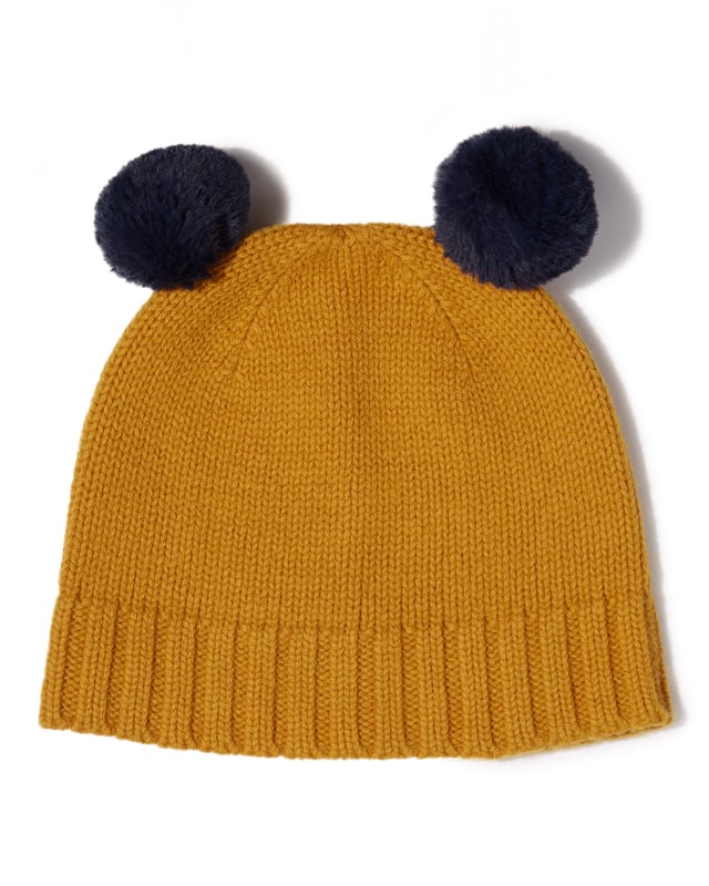 Keep your little one cosy this winter with this adorable wool hat featuring faux fur pom poms. Team with matching scarf and gloves for a cute combination. Available in classic navy and on-trend mustard.