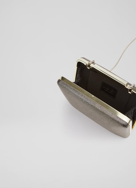 A modern interpretation of the classic box clutch, Dotty is designed for long-awaited parties. Crafted in Spain from beautiful fine glitter (which doesn't shed) in a luxurious bronze hue, it has a tapered, 3D rectangular shape, a chain shoulder strap and inside slip pocket. Wear it to add a subtle bit of shimmer and shine to any winter look.
