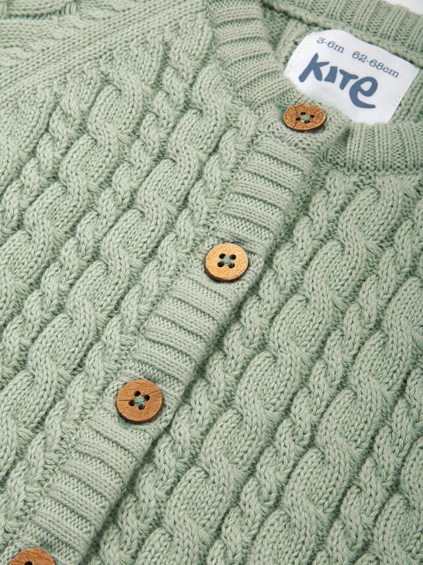 100% organic cotton | Proud to be certified to the Global Organic Textile Standard (GOTS) | Sage green | Midweight 7-gauge cable knit | Coconut button fastening | Long sleeved | Round neck | Rib cuffs and hem | Made in India | Machine washable at 40 degrees, or at 30 degrees to be kinder to the planet