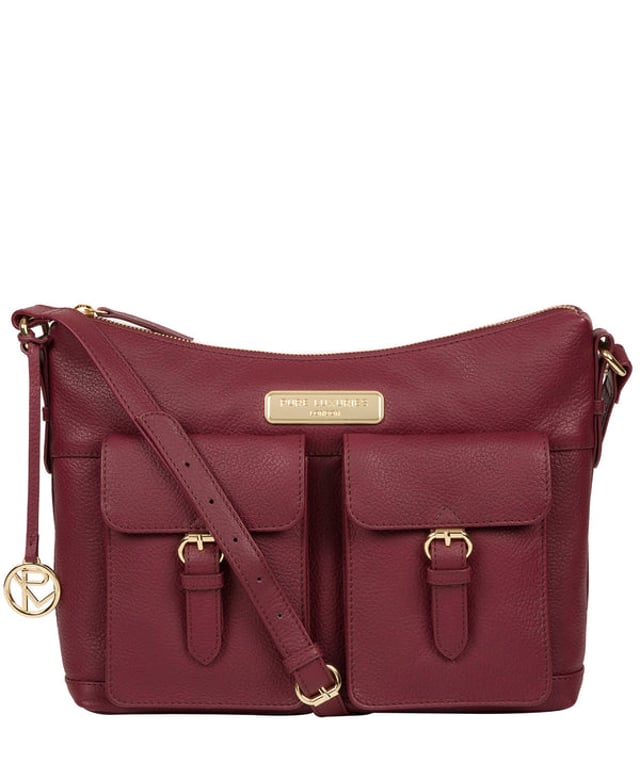 Crafted from leather that has soft pebble grain finish, the 'Jenna' shoulder bag from Pure Luxuries London comes with eye-catching gold-coloured fittings. The zip-over top secures a 100% cotton lined compartment, complemented by two internal pockets along with three external pockets that provide on-the-go storage; two of which are fastened with mock buckle press-studs. Comes with an adjustable matching leather strap and is adorned with the gold-coloured Pure Luxuries London charm and logo.