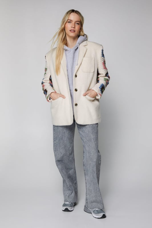 Layer up. Feel protected from the elements in our coat, in a cozy wool blend fabric, with crochet detailing. Pairs well with a casual fit for an elevated daytime look, or wear it over a mini dress for a levelled up night out look. Premium Wool Blend Crochet Blazer Coat High Quality Wool Blend Fabric Unique Crochet Style Details Comfortable Relaxed Fit Button Fastenings in Front Pocket Accents Model wears a size M (US size 6/UK size 10).