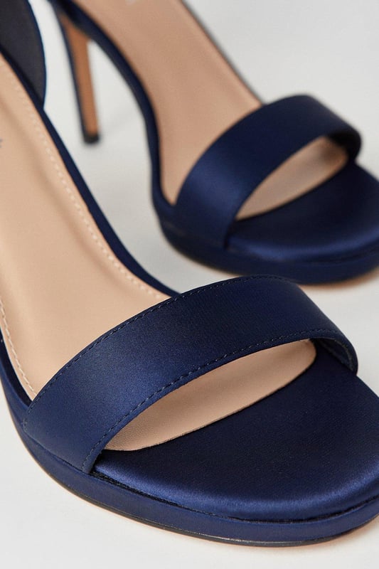 Elegant faux leather heeled sandals with a platform sole
Ankle strap with metallic buckle fastening for a secure fit
Open toe design to elongate the leg
Towering stiletto heel height of 7-9cm
Metallic finish exudes sophistication and glamour

Crafted with meticulous attention to detail, these Talia Platform Heeled Sandals from Coast are the epitome of refined elegance. Designed to make a statement at formal occasions like weddings, races, or graduations, these sandals radiate luxury. Style them with a floor-length gown or a tailored midi dress for a polished and sophisticated look that commands attention. Embrace the allure of these sandals and let them be the centerpiece of your ensemble, elevating your confidence and poise for an unforgettable evening.