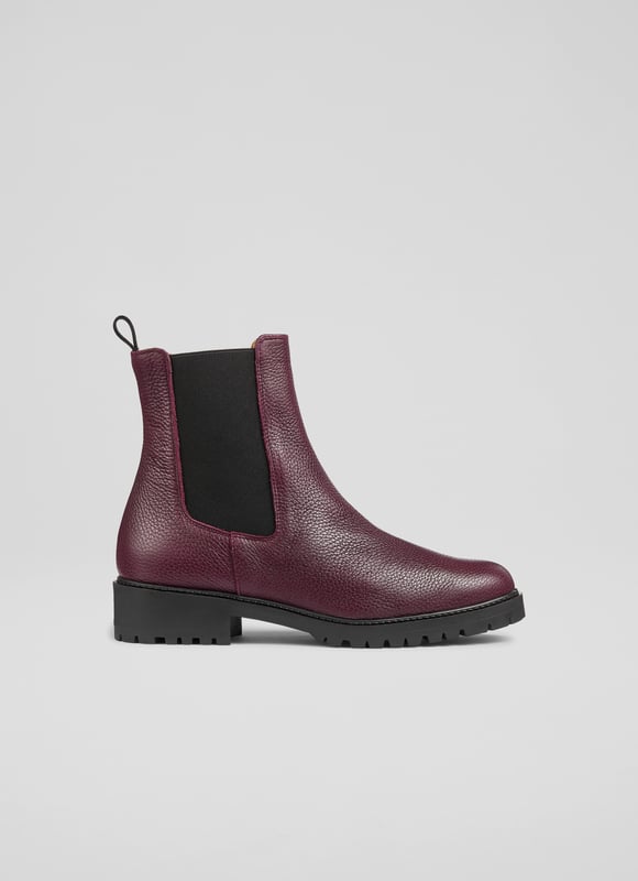 Make a bold statement with these Cadea ankle boots, perfect for casual wear. Crafted in Spain from luxurious textured leather, the tread sole boot features a round toe and a flat tread sole for ultimate comfort. These boots pair effortlessly with skinny jeans or a flowing midi dress for a stylish, versatile look.