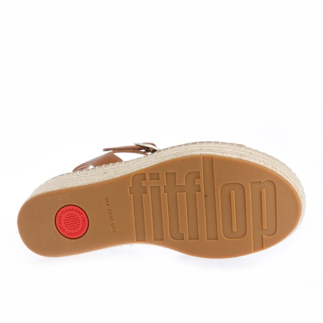 Womens FitFlop Eloise Espadrille Leather Back-Strap Wedge Sandals in light tan.Elevate your look - in every sense - with espadrille sandals on FitFlop's comfort-engineered high wedge sole.- Smooth high-quality leather uppers.- Lightly padded backstrap with adjustable buckle. - Comfortable cotton twill and leather-lined upper.- High wedge sole wrapped in natural jute for a laidback-chic summery vibe.- Statement stitching detail around the top of the sole.- Microwobbleboard midsole - absorbs shock  diffuses pressure and provides extraordinary comfort.- FitFlop branding to footbed.- Slip-resistant rubber outsole.- Average to wide fit.- Wedge height 2.8“ - 7.1cm approximately.- Leather and textile upper  Leather and textile lining  Synthetic sole.- Ref: HS5-592Measurements are intended for guidance only.