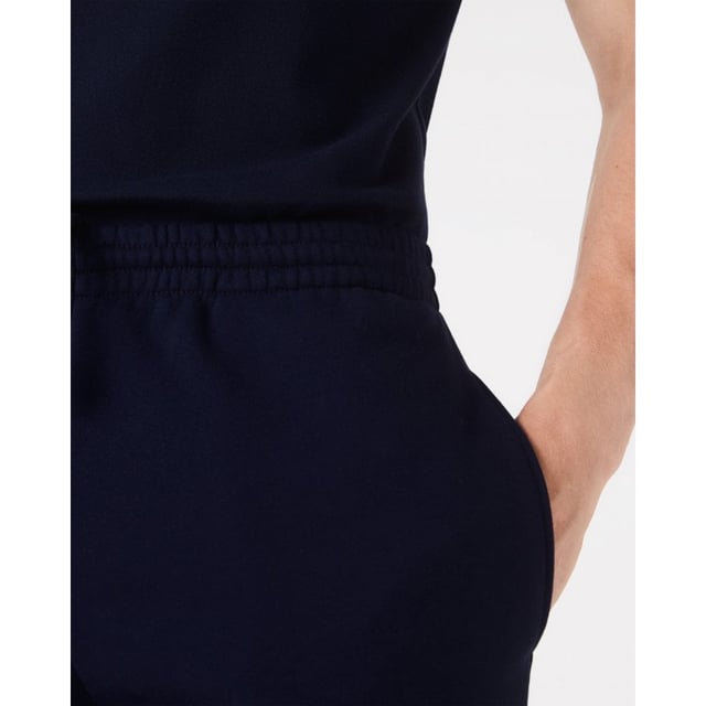 PRODUCT REF. GH9627-00 Efficient. Durable. Comfortable. An iconic, performance-enhancing essential that's comfortable enough to relax in. Regular fit, straight cut: Unrestricted freedom of movement. Drawstring waist: An adjustable waistband for optimum comfort. Back pocket with piping: Practical and functional. Embroidered crocodile on the front: Lacoste-typical performance. Brushed organic cotton fleece: Long-lasting comfort during sports. Main material: cotton (84%), polyester (16%) / pocket lining: cotton (100%)