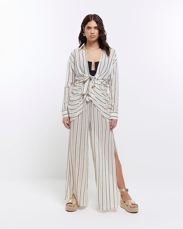 Stripe print, Mid rise, Flared design, Split hem, Elasticated waist, Made with at least 50% sustainable viscose, Our model wears a UK 8 and is 175cm/5'9'' tall