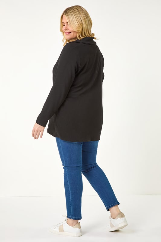 Curve Stretch V-Neck Collared Top from Roman. Elevate your casual style with this V-Neck jersey top, perfect for the Autumn/Winter season. Crafted from a textured jersey fabric, this top features a classic V-Neckline with a collar detail and comfortable long sleeves. The below hip length offers a flattering silhouette that pairs effortlessly with the matching trousers for a coordinated look. Complete your outfit with boots and a jacket for a chic and cozy ensemble.