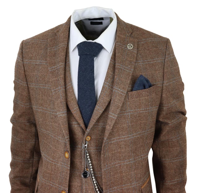 Sharp, sleek and sophisticated, look the part with this premium 3 piece Oak Brown tweed suit, that features a slim fit cut, with a closer fit across the chest and narrower tailored trousers. the two-button jacket hangs beautifully and has a half canvas construction that moulds to your body shape the more you wear it. Contrasting flap pockets, buttoned cuffs and a single back vent lend the suit a classic touch of refinement. A matching tweed waistcoat completes the 3-piece with a single breasted down style with classic tailored pockets and a back adjuster to ensure you can create your ideal fit. The suit is evergreen and contemporary at the same time and allowing you to look the best all day. Pair it with a matching waistcoat, a white shirt and shoes for a dapper finish.Perfect For Any Smart Formal Traditional Vintage Retro Themed Occasions, Such As Weddings, Proms Or Parties!Tailored Fit (inbetween Slim & Regular) Many More Styles & Colours Available in Store!