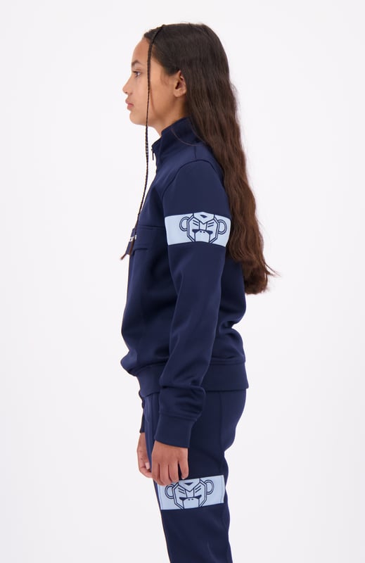 100 % Polyester Normale Passform Hoher Kragen mit halbem Reißverschluss Black Bananas Signatur-Klappe auf der Vorderseite Commander-Band am linken Arm Kombinierbar mit JR. COMMANDER TRACKPANTS 