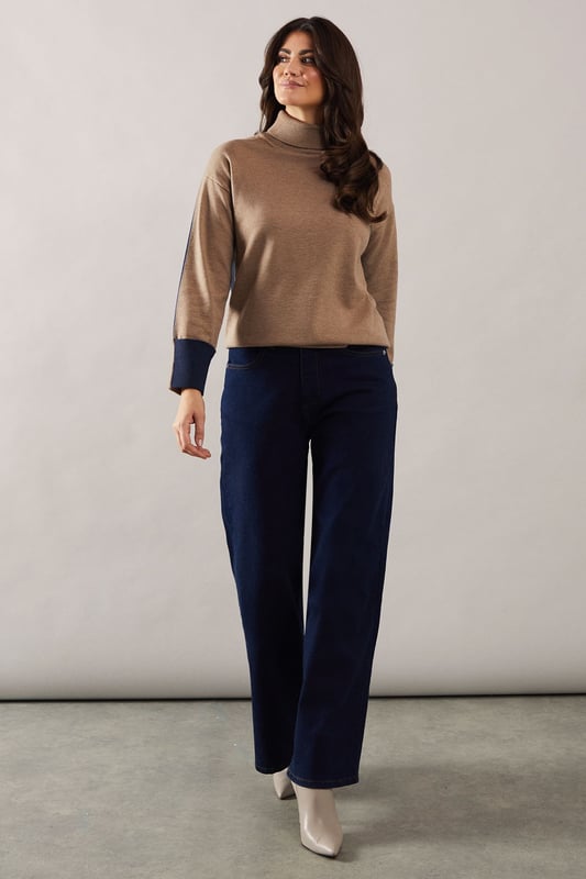 Asymmetric hem design for a modern twist
        Cosy roll neck for extra warmth and style
        Contrasting cuffs add a unique touch
        Relaxed tunic silhouette for comfort
        Versatile knitted fabric suitable for various occasions
    
    This Roll Neck Asymmetric Hem Tunic from Wallis is the epitome of sophisticated comfort. The asymmetric hem creates a flattering silhouette, while the roll neck offers both warmth and elegance. Perfect for those who appreciate a touch of glamour in their everyday wear, this tunic can be styled for various occasions. Pair it with wide-leg trousers and ballet flats for a chic daytime look, or dress it up with tailored trousers and heeled boots for evening gatherings. The contrasting cuffs add a subtle yet striking detail, making this piece stand out in your wardrobe. Whether you're attending a family lunch or meeting friends for coffee, this versatile tunic will keep you looking polished and feeling comfortable throughout the day.
