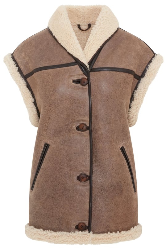Añade una elegancia atemporal a tu vestuario de invierno con este chaleco de piel de oveja de borrego para mujer, una combinación armoniosa de sofisticación y comodidad. Con un lujoso color marrón tostado, forro de piel de oveja afelpada y detalles de ribetes de cuero. Perfecto para usar en capas, combina una calidez excepcional con un encanto atemporal. • Piel de oveja de borrego de doble cara de primera calidad • Forro de piel de oveja afelpada para una comodidad superior • Cierre con botones para un aspecto clásico • Detalles de ribetes de cuero para una mayor elegancia • 2 bolsillos laterales para mayor comodidad • Cuello versátil, se puede llevar hacia arriba o hacia abajo para darle estilo y calidez