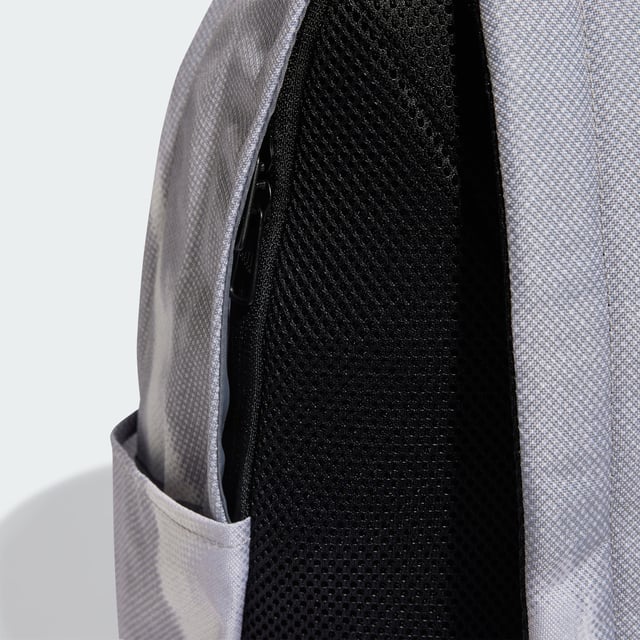 Weaving through city streets or escaping to the countryside, the adidas backpack makes a stylish yet practical choice. Padded, adjustable straps and a breathable mesh back panel ensure carrying comfort wherever the day takes you. Multiple pockets, inside and out, provide storage for life's essentials. This product is made with at least 50% recycled materials. By reusing materials that have already been created, adidas help to reduce waste and our reliance on finite resources and reduce the footprint of the products adidas make.  - Dimensions: 14.5 cm x 31 cm x 45 cm - Volume: 20.2 L - 100% polyester (recycled) - Mesh back panel and strap backing - Front zip pocket - Slip-in side pockets - Inner slip-in pocket - Padded adjustable shoulder straps - Carry handle  Shipped by adidas
