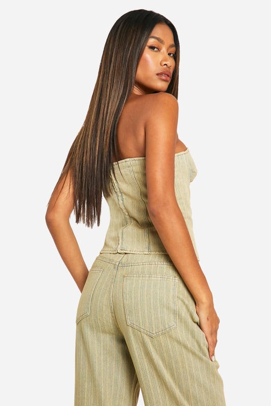 Strapless denim corset top with structured bustier design
        Flattering sweetheart neckline for a feminine silhouette
        Vertical seam detailing for a figure-enhancing effect
        Versatile toned denim fabric for day-to-night styling
        Pairs perfectly with matching wide-leg trousers for a coordinated look
    
    Make a bold statement with this eye-catching denim corset top from Boohoo. The structured bustier design and sweetheart neckline create a flattering silhouette that's sure to turn heads. Perfect for a night out on the town, this versatile piece can be dressed up or down to suit any occasion. Pair it with the matching wide-leg trousers and an oversized blazer for a chic, coordinated ensemble that's ideal for drinks with friends or dancing the night away. For a more casual look, team it with high-waisted jeans and trainers. The toned denim fabric adds a contemporary twist to the classic corset style, making it a must-have addition to your wardrobe. Whether you're hitting the club or meeting for cocktails, this corset top will ensure you stand out from the crowd.