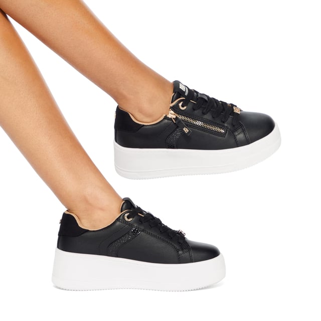This KG Kurt Geiger Lottie Lace Up sneaker arrives in black with wide laces and a gold zipper to one side. The hardware is gold and the chunky sole is in white.