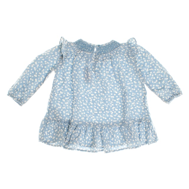 Baby dress with delicate details that enhance her charming style.

 The gathered collar gives it a special touch, and the long sleeves with ruffles on the shoulders add a romantic air.

 The skirt features a soft flare with a ruffle at the hem, adding movement and grace to the design.

 A perfect garment to combine comfort and elegance, ideal for both everyday and special occasions.
 Composition: 100% Viscose
 Care:
- Machine wash max. 30ºC.
 - Use similar colors in the wash.
 - Avoid the use of bleaches.
 - Dry at low temperature.
 - Iron at low temperature.
 - Do not dry clean.