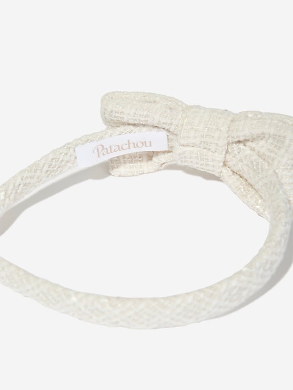 Introducing the Patachou Girls Special Occasion Bow Headband in pristine white, an essential addition for the sophisticated young lady's wardrobe for AW2024. Elegantly crafted for memorable events:‚ Exquisite White Bow: Features a large, elegant bow that adds a touch of class and timeless charm.‚ Premium Fabric: Constructed from superior quality fabrics, ensuring comfort and durability for all-day wear.‚ Versatile Elegance: Perfectly complements formal outfits, enhancing your girl's ensemble with its subtle grace.Elevate her special occasion attire with this Patachou headband. Shop now and let her shine in style!