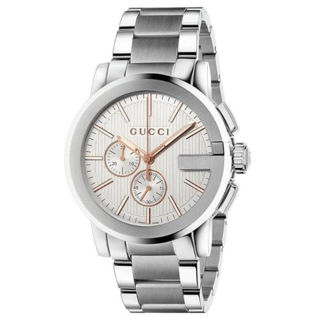 Designed to make a unique statement of modern excess, this eye-catching Gucci G-Chrono New XL chronograph men's watch blends luxury styling with the art of Swiss watchmaking.  A symbol of modern luxury, Gucci are famous for their signature style and innovative design aesthetics, and have become synonymous with quality, Italian craftsmanship and fashion authority.  Fastened with a contemporary brushed and polished stainless steel bracelet with three blade deployment buckle, the imposing 44mm brushed and polished stainless steel case is finished with the instantly recognisable G-frame bezel.  Beneath the unscratchable sapphire crystal with anti-reflective coating inside, the distinctive silver coloured dial features a vertical guilloche pattern which pays tribute to the skill of the Gucci Craftsmen, and is given a modern edge with the rose golden baton hour markers, skeletonized hands and two chronograph sub-dials.  Water resistant to 30m, this statement watch is powered by a Swiss Made Ronda quartz movement.  Showcasing oversized Gucci style which can't fail to turn heads, this handsome watch features statement design cues which combine to form a powerful statement of personality. 