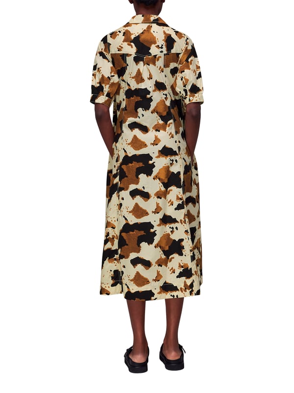 Embrace the statement look with our Cow Print Midi Shirt Dress, perfect for daytime flair or a casual weekend ensemble.