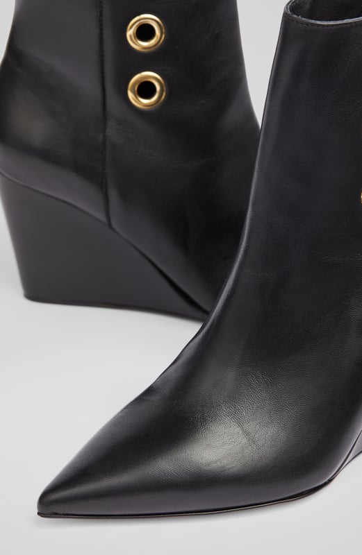 LK Bennett Brie Ankle Boots,Black A stand-out pair of ankle boots in our new collection, the Brie boots offer wear-all-day comfort and contemporary chic in equal measure. Beautifully made in Italy from buttery soft black nappa leather, they have a pointed toe, gold eyelet detail, an inside zip and a leather wedge 80mm heel. Sleek and sexy, slip them on with dresses and skirts as well as smarter, more tailored looks.