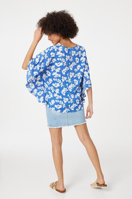 Every warm weather wardrobe needs a versatile floral print like this relaxed fit blouse. It has a V-neck, 1/2 length flared batwing sleeves, a relaxed fit and a hip length hem. Pair with your favourite sandals or flats for a stylish off-duty look.