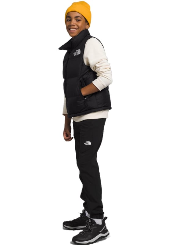 The North Face Nuptse has been delivering game-changing warmth since 1992 and no other jacket has journeyed so naturally from the mountains to city streets. - - .   The Teens' 1996 Retro Nuptse Gilet is a modern reincarnation of the icon, built for young adults. - - .  We’ve kept most things the same: the same boxy silhouette; the same shiny ripstop fabric; the same exposed zip and diagonal hand pockets and, of course, the same oversized baffles. - - .  The only change is upgrading to 700-fill of responsibly sourced down. - - .  It's also made with recycled materials, making it kinder to nature. - - . Shell: 100% Nylon, Lining: 100% Polyester, Filling: 90% Down, 10% Waterfowl Feathers.