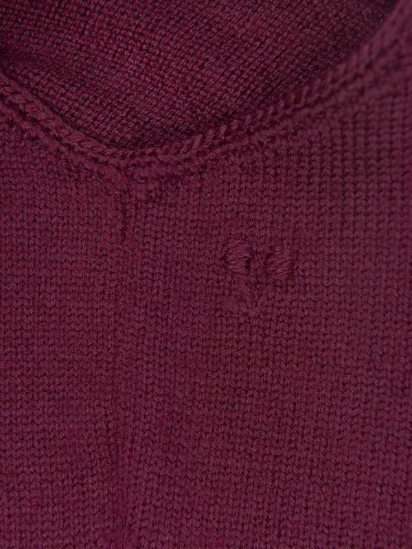 A charming rompersuit designed for your little one by luxury label Bonpoint. The rich purple suit is constructed from soft wool with a crossover back and delicate button fastenings on the straps. Layered up or worn alone, this is a timeless piece for your baby.