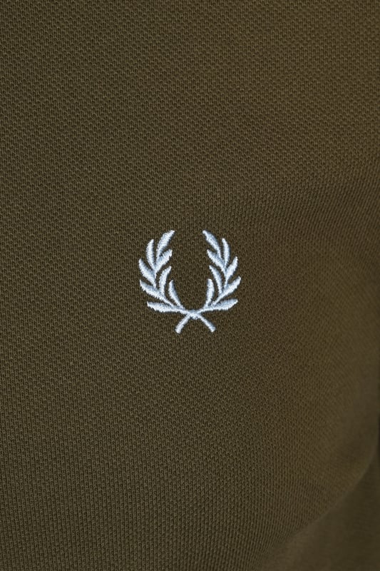 Fred Perry Plain Polo Shirt Uniform Green
An easy to style polo shirt by Fred Perry for your casual wardrobe. In an khaki green colourway boasting the signature Laurel Wreath in contrasting colours it is a minimal design. Pair with your favourite denim and designer trainers for a relaxed look.

100% Cotton
Two Button Placket
Ribbed Cuffs
Signature Fred Perry Branding
Style: M6000