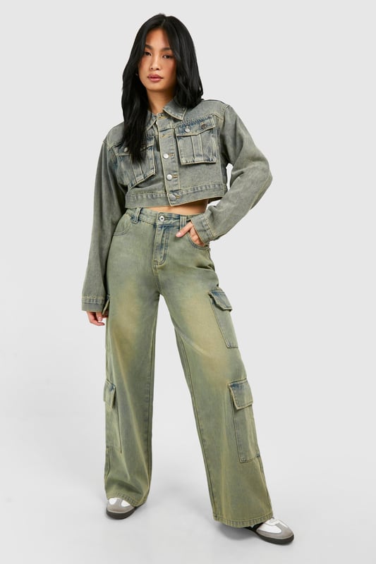 Wide leg cargo jeans with vintage wash effect
        Multiple utility pockets for added functionality
        Cropped jacket with matching wash and pocket details
        High-waisted design for a flattering silhouette
        Relaxed fit through legs for comfort and style
    
    Make a bold statement with these eye-catching cargo jeans, perfect for the fashion-forward trendsetter. The wide-leg silhouette offers a contemporary twist on a classic denim style, whilst the vintage wash adds character and depth. Pair with the coordinating cropped jacket for a head-turning denim-on-denim ensemble that's sure to turn heads. For a casual daytime look, team with a simple white crop top and trainers. Dress it up for evening drinks by swapping trainers for heeled boots and adding statement jewellery. These versatile jeans are ideal for various casual occasions, from weekend brunches to music festivals. The multiple pockets not only add to the utilitarian aesthetic but also provide practical storage for your essentials. Embrace the Y2K revival trend and make these cargo jeans your go-to piece for effortless, street-style inspired outfits.