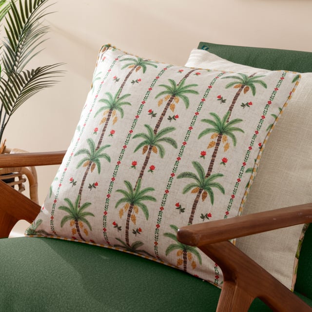 Enhance your living space with the Okara Palm Piped Cushion. Featuring a hand-painted design that juxtaposes delicate florals with bold palm tree motifs, this cushion offers a refined yet relaxed aesthetic. The textured linen-look fabric adds depth and versatility, while the piped trim provides a refined finish. With its intricately patterned reverse, this cushion effortlessly blends modern and tropical inspirations, making it an ideal accent for a variety of interior styles. Perfect for those who appreciate the beauty of nature and the charm of thoughtful design.