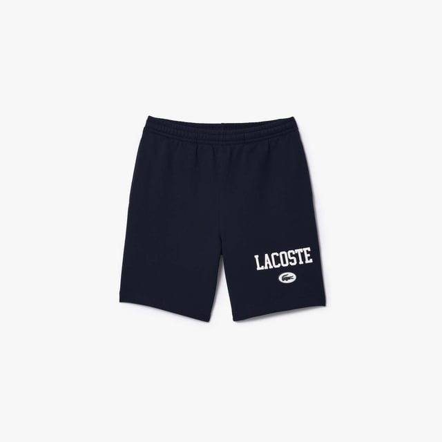Own the french fashion sport The Joggers tracksuits : Comfort shape Regular fit  regular ease on body  hip and leg Shorts in our classic French Terry Climbing style drawcords 5cm puffed badge with silicone crocodile sewn at bottom Lacoste wording in flock print.