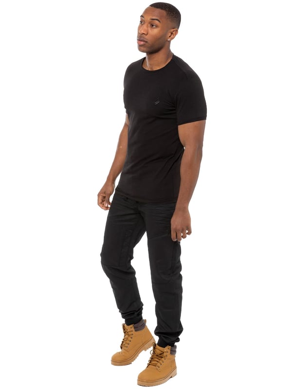 Enzo Mens Cuffed jogger jeans. Printed branding on the front and back. Branded buttons, rivets and trimmings. Overall profile stitched, creasing on front and back. Cotton blend, Cut and sew panelling. Waist adjustable drawstrings.