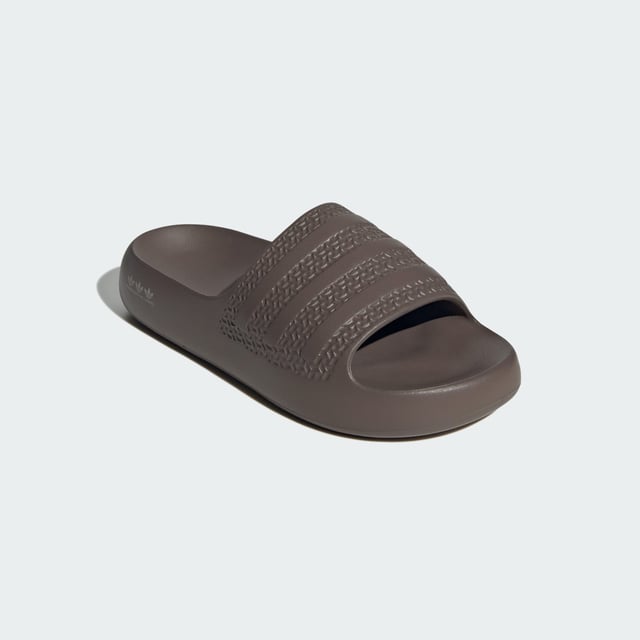 The moment you step into these adidas Adilette Ayoon Slides, you're at ease. That's the whole point of them. They let you bring the comfort of home with you anywhere, thanks to the super soft one-piece EVA foam build. That minimalist approach extends beyond the construction — the colours also keep things toned down, which happens to mean that they also style well with everything.  - Slip-on - EVA upper - Ultra-soft feel - EVA outsole  Shipped by adidas