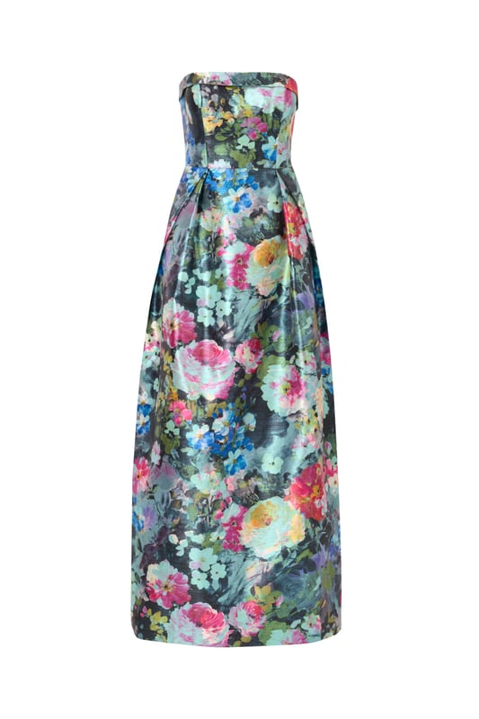 Luxurious details elevate this metallic floral ball gown. This evening gown features a fitted bodice with boning for structure, a strapless straight neckline with fold over detail, and a full ball skirt. Designed from floral print metallic jacquard fabric imported from France, this ball gown has crinoline under the pleated skirt for added volume. A hidden zipper closure at the centre back and pockets within the skirt completes this strapless gown. A perfect look for a black-tie event or formal wedding, this floral gown looks great when paired with nude heels and a statement-making clutch.