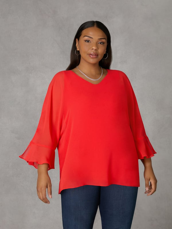 In striking red, this top has a super soft, stretchy jersey vest-style underlayer for that all-important coverage, and an elegant, floaty chiffon overlayer that moves beautifully. With bracelet-length, fluted sleeves and a lengthening V-neck, it has a swingy A-line shape thats designed to flatter. Dress this up or down, depending on your plans.