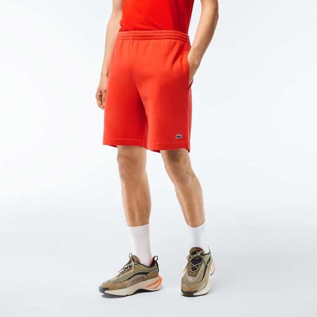 Men's Lacoste Organic Brushed Cotton Fleece Shorts Regular fit  straight cut: Unrestricted movement. Drawstring at waist: An adjustable waistband for optimal comfort. Piped back pocket: Practical and functional. Embroidered crocodile sewn onto front: Lacoste signature performance. Brushed organic cotton fleece: Long-lasting comfort during practice.