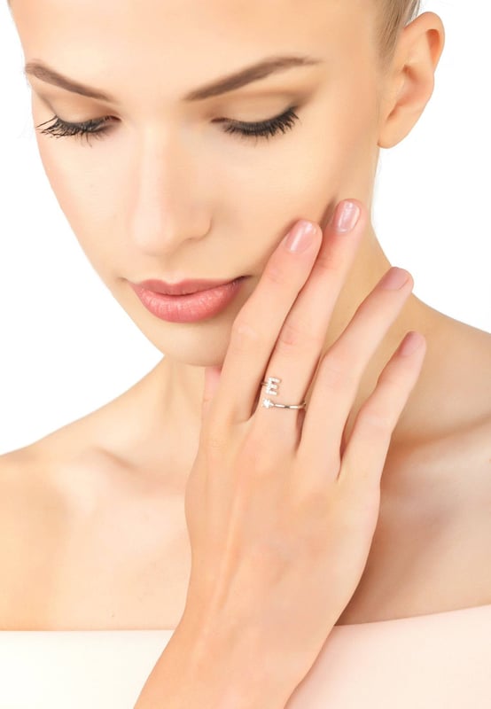 Design:This simple but beautifully styled initial letter ring is perfect for those who covet delicate jewellery with a hint of sparkle offering a sophisticated finishing touch to any outfit.Pretty and petite, this initial ring features an open band, which allows for slight adjustability with sizing. The opening is designed to be on top of your finger, where your zircon adorned monogram is on one side and a single larger cubic zirconia resides on the other.What can be more personal than a name? Give this initial ring as the perfect personalised birthday gift.This ring is made as an average size 6 (M) with a small amount of flexibility, that can easily be squeezed or opened very gently, to allow for a better fit.This ring looks great stacked with other rings.  Materials:Handcrafted using 925 sterling silver. White cubic zirconia.Style Notes:Personalised birthday gift ideas. Bridesmaid gifts. Simple everyday styling.Dimensions:One size only (average size 6 (M) with slight flexibility)Packaging:This item is presented in a Latelita London signature jewellery box.Care Instructions:To maintain your jewellery, wipe gently with a damp cloth that is soft and clean. Do not soak in water. Avoid contact with soaps, detergents, perfume or hair spray.