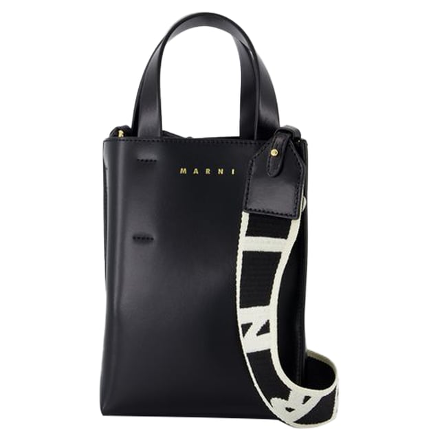 Fit: true to size - Sizing: European. Closure: open top. Interior: two compartments and two zipped pockets.