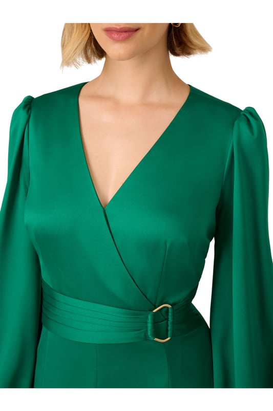 Short length mermaid dress made out of a solid satin fabric with surplice neckline, long sleeves, shirred self-tie belt and gold ring detail on the waist, inserted godet skirt, and zipper at the centre back.