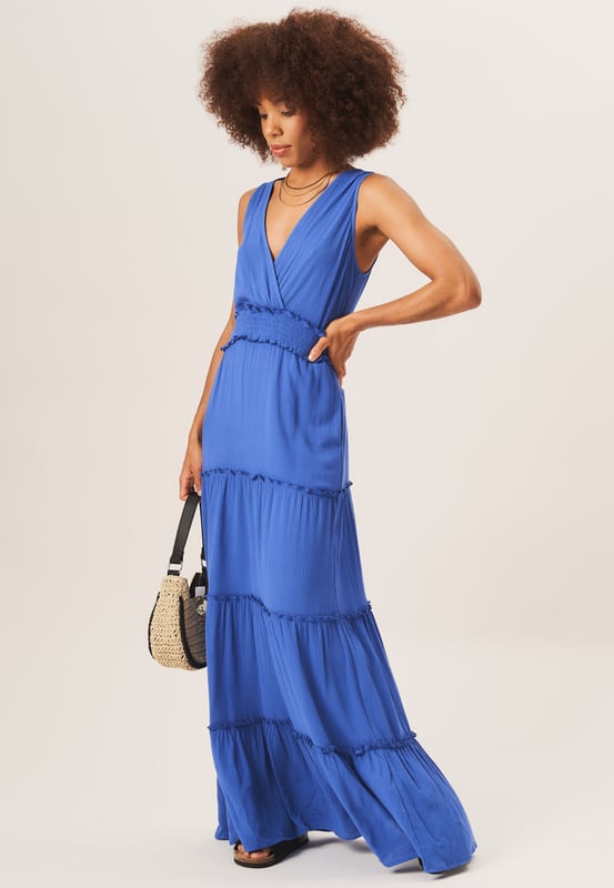 Stay stylish and comfortable in our  Shirred Waist Tiered Midi Dress. This versatile dress features a flattering shirred waist and a tiered design for a fashionable look. Perfect for any occasion, it will effortlessly elevate your wardrobe.