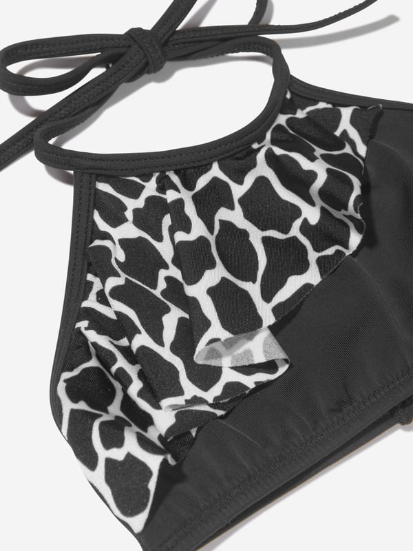 Unveiling the Girls Tinto Bikini (UV50 Sun Protection) by Nessi Byrd, an ultimate showstopper for your little girl's summer wardrobe. Key features: Elegant Design: Crafted to perfection with a designer finish, mixing style with sun protection for your little diva.  UV50 Sun Protection: Maximum protection against harmful sun rays, offering carefree fun under the sun. Luxurious Comfort: Made from unique, high-end fabric for unrivalled comfort and durability, withstanding countless beach adventures.  Unrivalled Quality: A product of Nessi Byrd's renowned quality, prepare to dazzle at the beach with this designer piece. Order now, upgrade your little girl's summer style!