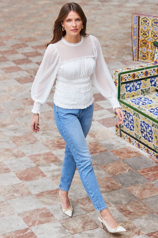 REASONS TO BUY:

We predict compliments
Stylish - and super-comfy - shirred bodice
Stunning sheer neckline and blouson sleeves
Frill trims amplify the romance
Take jeans and a nice top to new levels
Add sparkly earrings for maximum impact
