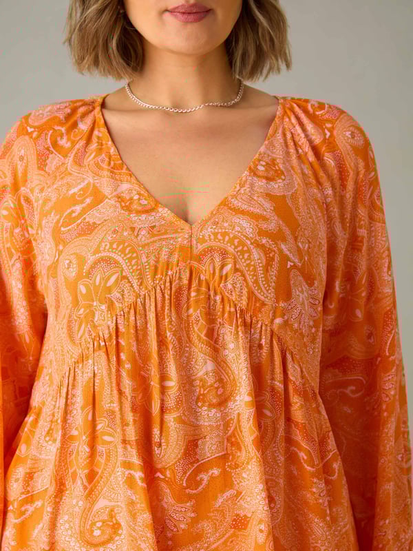 In a pretty orange paisley, this tunic is cut from a soft woven fabric thats so comfortable to wear. With a lengthening V-neckline, it has a bust seam and full-length elasticated sleeves which create a stylish silhouette. Its long, tunic length adds to its flattering feel, making it the perfect everyday piece.