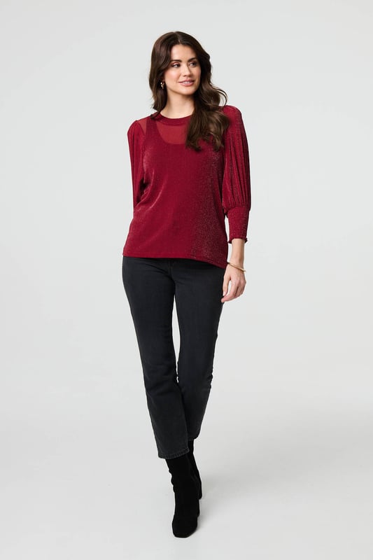 Dress for a smart-casual occasion with this glittery top. It has 3/4 puff sleeves and a hip length hem, along with a round neck and a relaxed fit. Just pair with fitted jeans and heels for the perfect laid-back occasion wear outfit.