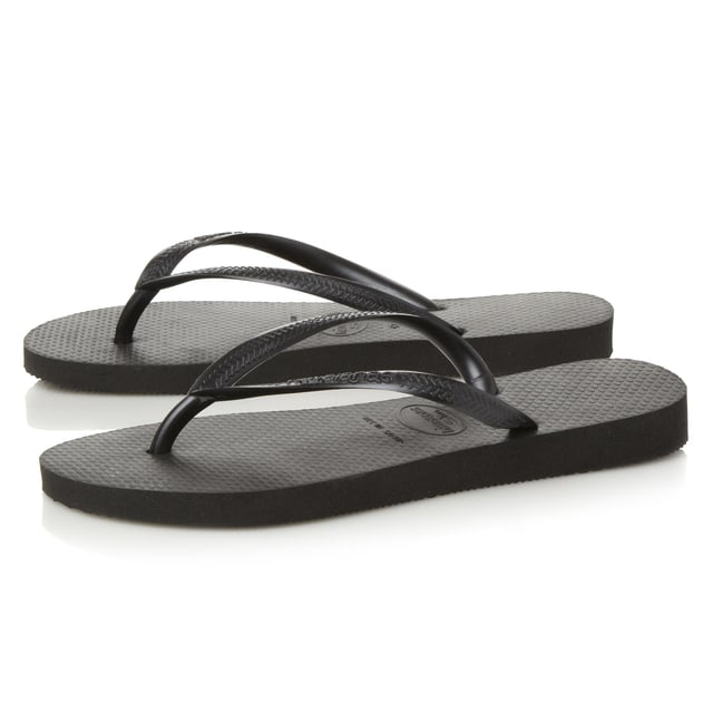 Embrace the summer in this casual flip flop by Havaianas. Slim fit design with white sole and toe post. Sizing is an adjusted fit meaning the foot fits to the edge of the sole.