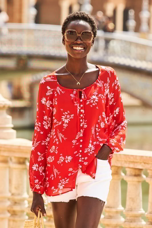 REASONS TO BUY:

Florals to make you feel good
Flattering scoop neck and longline hem
Button front and tie neck detail
Semi-sheer fabric
On-trend blouson sleeves
Wear it with white shorts and wedges